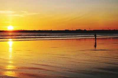 Scenic view of beach against sky during sunset