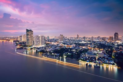 Illuminated city at waterfront