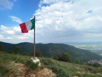 Flag on landscape against sky