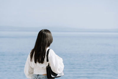 Rear view of woman looking at sea