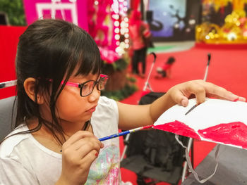 Close-up of cute girl painting craft product 