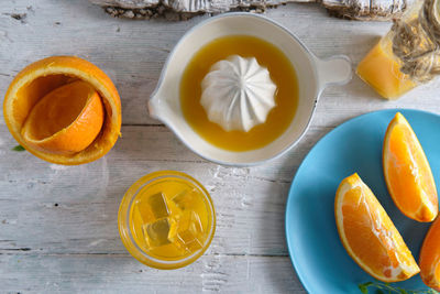 Summer still life with white wood background of orange juice where we