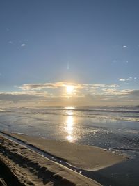 Scenic view of beach against sky during sunset