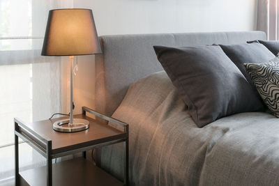 Electric lamp on sofa at home