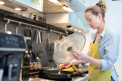 Woman preparing food in kitchen