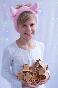 Portrait of smiling girl holding toy