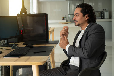 Side view of man using mobile phone