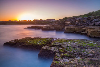 Scenic view of river against sky during sunset