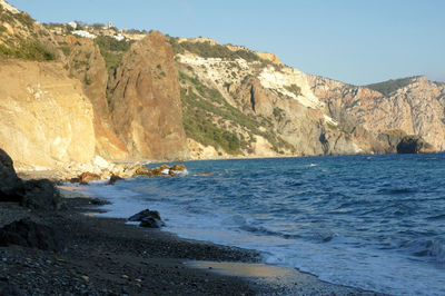 Scenic view of sea and mountains against sky