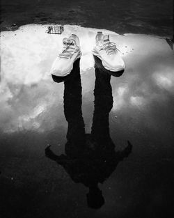 Low section of man standing in swimming pool