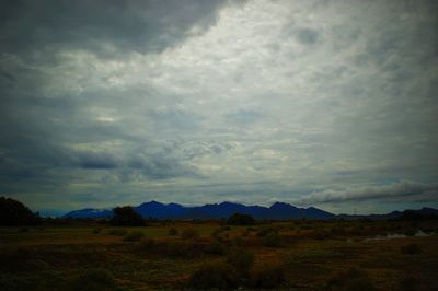 Scenic view of landscape against cloudy sky