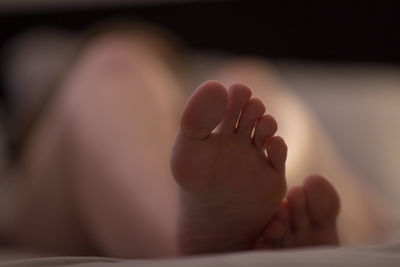 Close-up of baby feet on bed