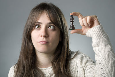 Portrait of teenage girl against gray background