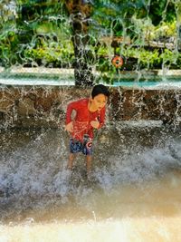 Boy splashing water