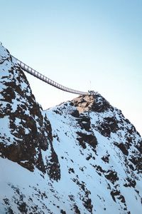 Scenic view of snowcapped mountain against clear sky