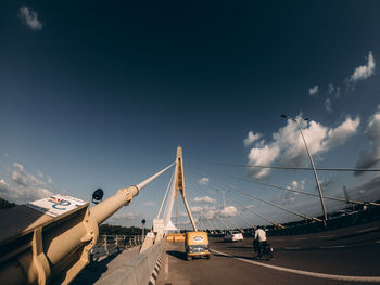 Cars on bridge against sky