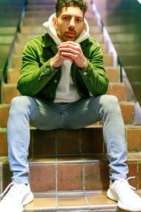 Portrait of young man sitting outdoors