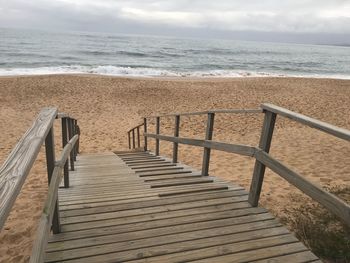 Steps on beach against sky