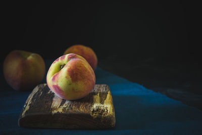 Close-up of apple on table against black background