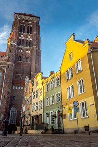 Low angle view of yellow building against sky