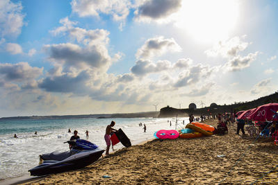 People on beach against sky