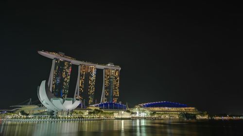 Illuminated built structure against sky at night