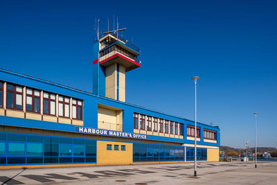 Low angle view of building against clear blue sky