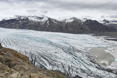 Scenic view of mountains and glacier against sky