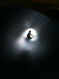 Rear view of silhouette man in tunnel