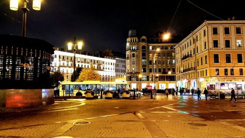 Illuminated city street and buildings at night