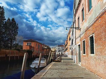 Street amidst buildings against sky