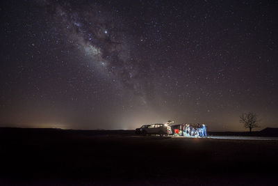 Scenic view of car against sky at night