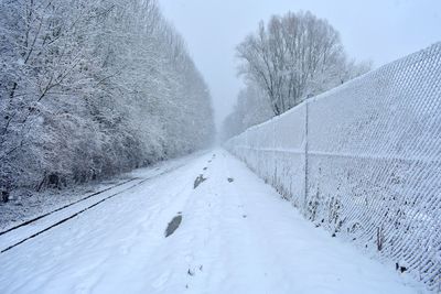 Snow covered road against sky