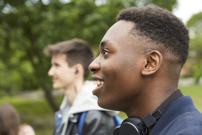 Smiling teenage boy looking away