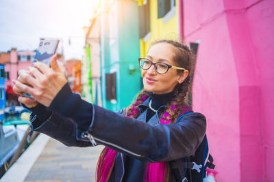 Portrait of young woman using mobile phone