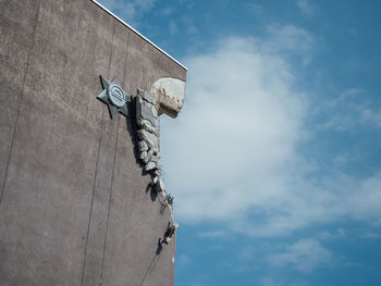 Low angle view of old sculpture against sky