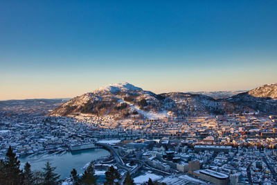 Aerial view of townscape against sky during winter