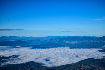 Scenic view of mountains against blue sky