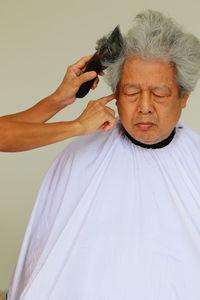 Close-up portrait of a woman over white background
