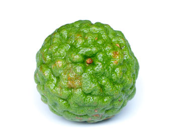 Close-up of water drops on fruit against white background