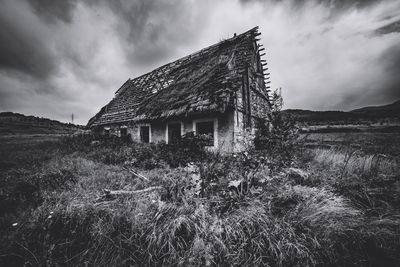 Old building on field against sky