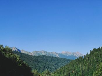 Scenic view of mountains against clear blue sky