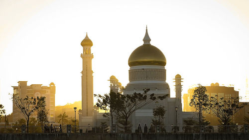 View of buildings in city against clear sky