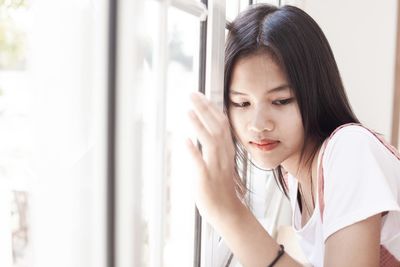 Portrait of a beautiful young woman looking down