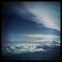 Scenic view of mountains against cloudy sky