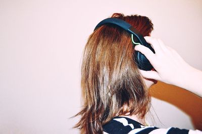 Woman listening music against white background