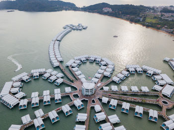 High angle view of boats in river against buildings