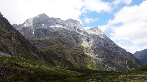 Scenic view of mountains against cloudy sky