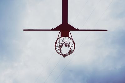 Low angle view of basket hoop against sky