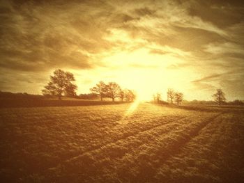 Scenic view of field against cloudy sky